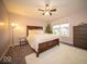Cozy main bedroom with a large window for lots of natural light, neutral wall paint, and plush carpet at 9949 Stable Stone Ter, Fishers, IN 46040