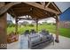 Inviting covered patio with comfortable seating, swing, and elegant decor, perfect for entertaining guests outdoors at 9949 Stable Stone Ter, Fishers, IN 46040