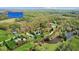 Aerial view of the property with manicured lawns, pond, pool, outbuildings and surrounding trees at 10220 N Serenity Ln, Mooresville, IN 46158
