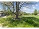 Expansive backyard with a pond and mature trees create a serene environment at 10220 N Serenity Ln, Mooresville, IN 46158