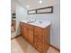 Bathroom features a double sink vanity with neutral countertops, wood cabinets, and a tile floor at 10220 N Serenity Ln, Mooresville, IN 46158
