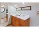 Bathroom features a double sink vanity with neutral countertops, wood cabinets, and a tile floor at 10220 N Serenity Ln, Mooresville, IN 46158