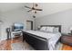 Well-lit bedroom featuring a ceiling fan and TV, complete with a comfortable bed and stylish decor at 10220 N Serenity Ln, Mooresville, IN 46158
