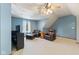 Bonus room with hardwood floors, blue accent wall, and comfortable leather seating at 10220 N Serenity Ln, Mooresville, IN 46158