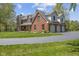 Brick home with an attached garage and large front yard with circular drive at 10220 N Serenity Ln, Mooresville, IN 46158