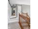 Upstairs hallway with neutral colored walls and carpet and decorative wood trim at 10220 N Serenity Ln, Mooresville, IN 46158