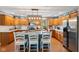 Spacious kitchen with a kitchen island and breakfast bar, and stainless steel appliances at 10220 N Serenity Ln, Mooresville, IN 46158