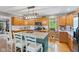 Bright kitchen with wood cabinets, a center island with bar seating, and stainless appliances at 10220 N Serenity Ln, Mooresville, IN 46158