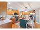 Well-lit kitchen featuring wood cabinets, an island with bar seating, and stainless steel appliances at 10220 N Serenity Ln, Mooresville, IN 46158