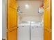 Convenient laundry area with a washer and dryer, complete with storage shelves and a folding door at 10220 N Serenity Ln, Mooresville, IN 46158
