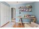 Bright home office featuring a wooden desk, ample shelving, and a comfortable chair, creating an inspiring workspace at 10220 N Serenity Ln, Mooresville, IN 46158