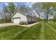 White outbuilding with an overhead door and well-manicured lawn at 10220 N Serenity Ln, Mooresville, IN 46158