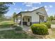 Charming outbuilding with covered porch, decorative doors and lush greenery at 10220 N Serenity Ln, Mooresville, IN 46158