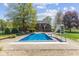 Large in-ground pool with a slide and well-maintained patio great for outdoor gatherings at 10220 N Serenity Ln, Mooresville, IN 46158