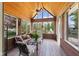 Relaxing sunroom featuring brick floors and walls, large windows, and comfortable seating at 10220 N Serenity Ln, Mooresville, IN 46158