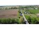 Aerial view of home with lush green yard, detached garage, landscaping, a bridge, and beautiful scenery at 10776 S 250 W, Flat Rock, IN 47234