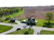 An aerial view shows the property's rural location with the home, outbuilding, fields, and stream at 10776 S 250 W, Flat Rock, IN 47234