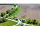 An aerial view shows the property's rural location with the home, outbuilding, fields, and stream at 10776 S 250 W, Flat Rock, IN 47234