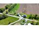 An aerial view shows the property's rural location with the home, outbuilding, fields, and stream at 10776 S 250 W, Flat Rock, IN 47234