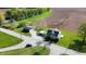 An aerial view shows the property's rural location with the home, outbuilding, fields, and stream at 10776 S 250 W, Flat Rock, IN 47234