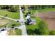 Aerial view of a quaint green home with charming porch, detached garage and bridge access to neighborhood and farmland at 10776 S 250 W, Flat Rock, IN 47234