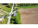 Aerial view of a quaint green home with charming porch, detached garage and bridge access to neighborhood and farmland at 10776 S 250 W, Flat Rock, IN 47234
