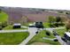 An aerial view shows the property's rural location with the home, outbuilding, fields, and stream at 10776 S 250 W, Flat Rock, IN 47234