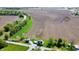 An aerial view shows the property's rural location with the home, outbuilding, fields, and stream at 10776 S 250 W, Flat Rock, IN 47234