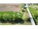 Aerial view of home with lush green yard, driveway, landscaping, detached garage, large lot, and river at 10776 S 250 W, Flat Rock, IN 47234