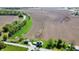 An aerial view shows the property's rural location with the home, outbuilding, fields, and stream at 10776 S 250 W, Flat Rock, IN 47234