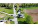 Aerial view of a quaint green home with charming porch, detached garage and bridge access to neighborhood and farmland at 10776 S 250 W, Flat Rock, IN 47234