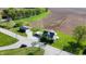 An aerial view shows the property's rural location with the home, outbuilding, fields, and stream at 10776 S 250 W, Flat Rock, IN 47234
