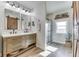 Well-lit bathroom features a double vanity, sliding barn door mirror, and walk-in shower at 10776 S 250 W, Flat Rock, IN 47234