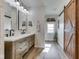 Bathroom features a double vanity, sliding barn door mirror, and decorative elements at 10776 S 250 W, Flat Rock, IN 47234