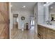 Bathroom with double vanity, toilet, and doorway view into the main bedroom at 10776 S 250 W, Flat Rock, IN 47234