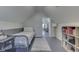 Bright bedroom offers gray wood floors, a single bed, and access to a hallway at 10776 S 250 W, Flat Rock, IN 47234