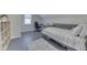 Charming bedroom features gray wood floors, a single bed, and a dedicated desk space at 10776 S 250 W, Flat Rock, IN 47234