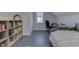 Cozy bedroom features gray wood floors, a single bed, and a dedicated desk space at 10776 S 250 W, Flat Rock, IN 47234