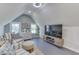 Cozy bonus room features vaulted ceilings, gray wood floors, a TV, and comfortable seating at 10776 S 250 W, Flat Rock, IN 47234