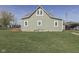 Exterior of a home with an attached wooden deck in the backyard and a lush lawn at 10776 S 250 W, Flat Rock, IN 47234