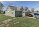 Charming two-story home with a carport and well-maintained lawn on a sunny day at 10776 S 250 W, Flat Rock, IN 47234