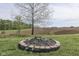 Stone fire pit providing an outdoor space for relaxation and entertainment with farmland views at 10776 S 250 W, Flat Rock, IN 47234