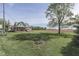 Picturesque home with a sprawling front lawn and a charming two-story farmhouse with wraparound porch at 10776 S 250 W, Flat Rock, IN 47234