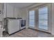 Functional laundry room with washer, dryer, and access to the backyard at 10776 S 250 W, Flat Rock, IN 47234