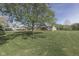 Expansive front yard with mature trees and a charming home in a serene setting at 10776 S 250 W, Flat Rock, IN 47234