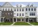 Modern townhomes with brick, stone, and siding exteriors and well-manicured lawns create an inviting curb appeal at 10959 Belgian Ln, Zionsville, IN 46077