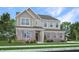 Charming two-story home featuring a combination of brick and siding, surrounded by a well-maintained lawn and garden at 1103 Marston Ln, Avon, IN 46123
