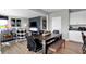 Open-concept dining area with modern table and chairs, flowing into a living space and kitchen at 1178 Turner Trace Pl, Avon, IN 46123