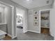 Hallway with access to a bedroom, laundry room, and a soothing, neutral color scheme throughout at 1178 Turner Trace Pl, Avon, IN 46123