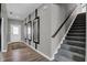 Hallway featuring modern mirrors, wood-look floors and a staircase at 1178 Turner Trace Pl, Avon, IN 46123